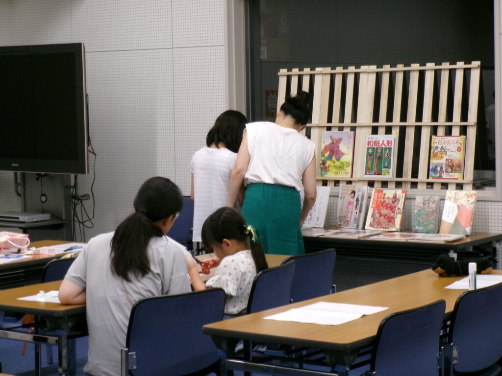 本を見ながら、どんなしおりにしようか考えています