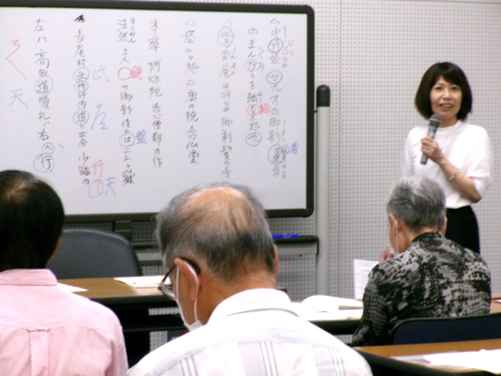 講座の画像。ホワイトボードの横で講師の先生が説明をしている様子。